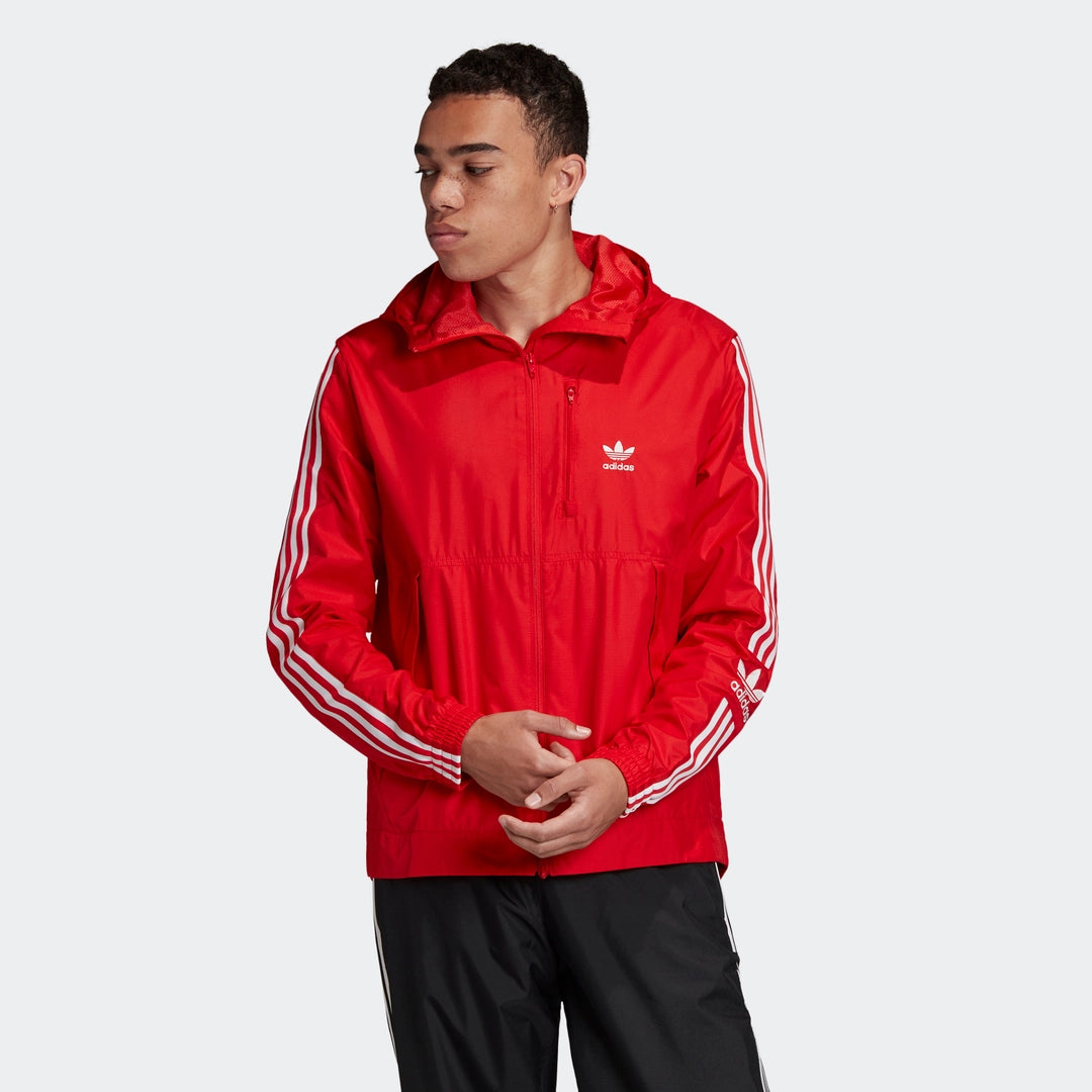 “Leuchtend rote Adidas Lock Up Windbreaker Jacke. Leichtes, wasserabweisendes Material, durchgehender Reißverschluss, hoher Kragen, seitliche Reißverschlusstaschen, kleines Adidas Trefoil Logo auf der Brust.“
