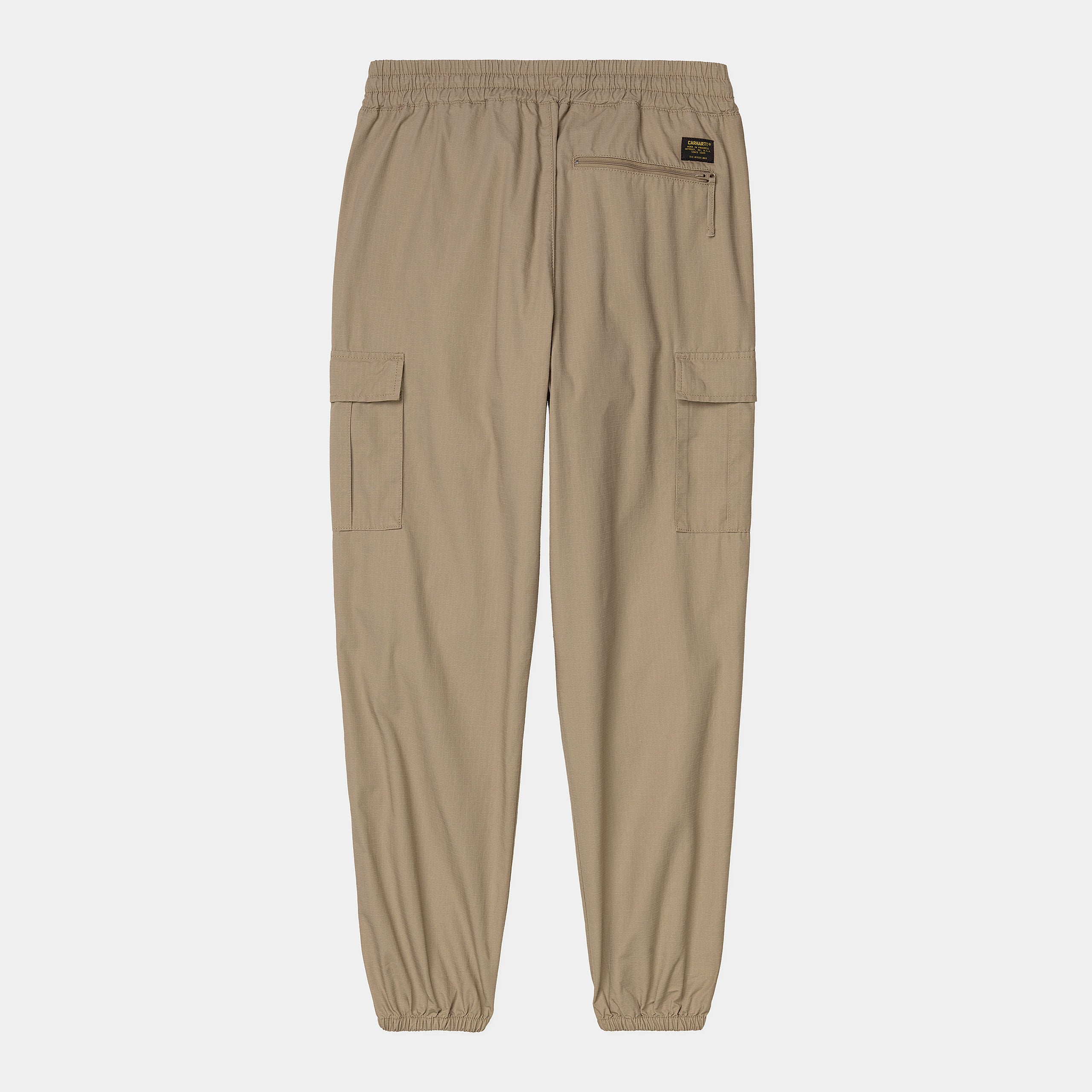 Carhartt WIP Cargo Jogger in Leather (rinsed), robuste braune Baumwollhose mit seitlichen Cargo-Taschen, elastischem Bund und Beinbündchen im Tapered Fit.