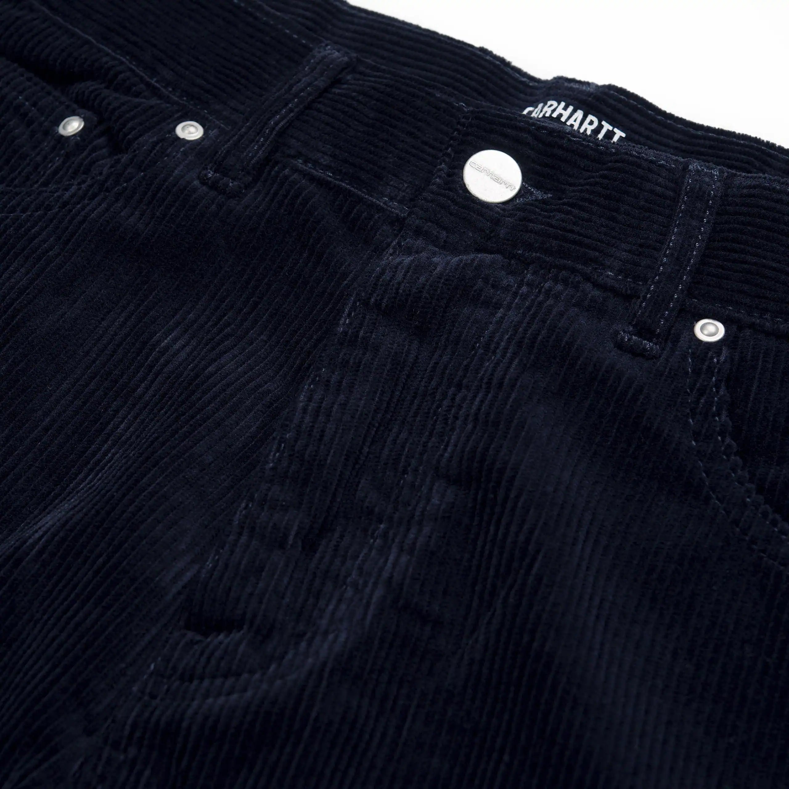 "Carhartt Newel Pant in Dunkelblau (Rinsed), Cordhose aus Baumwolle, lockere Passform, klassische Jeanshose in tiefem Marineblau."