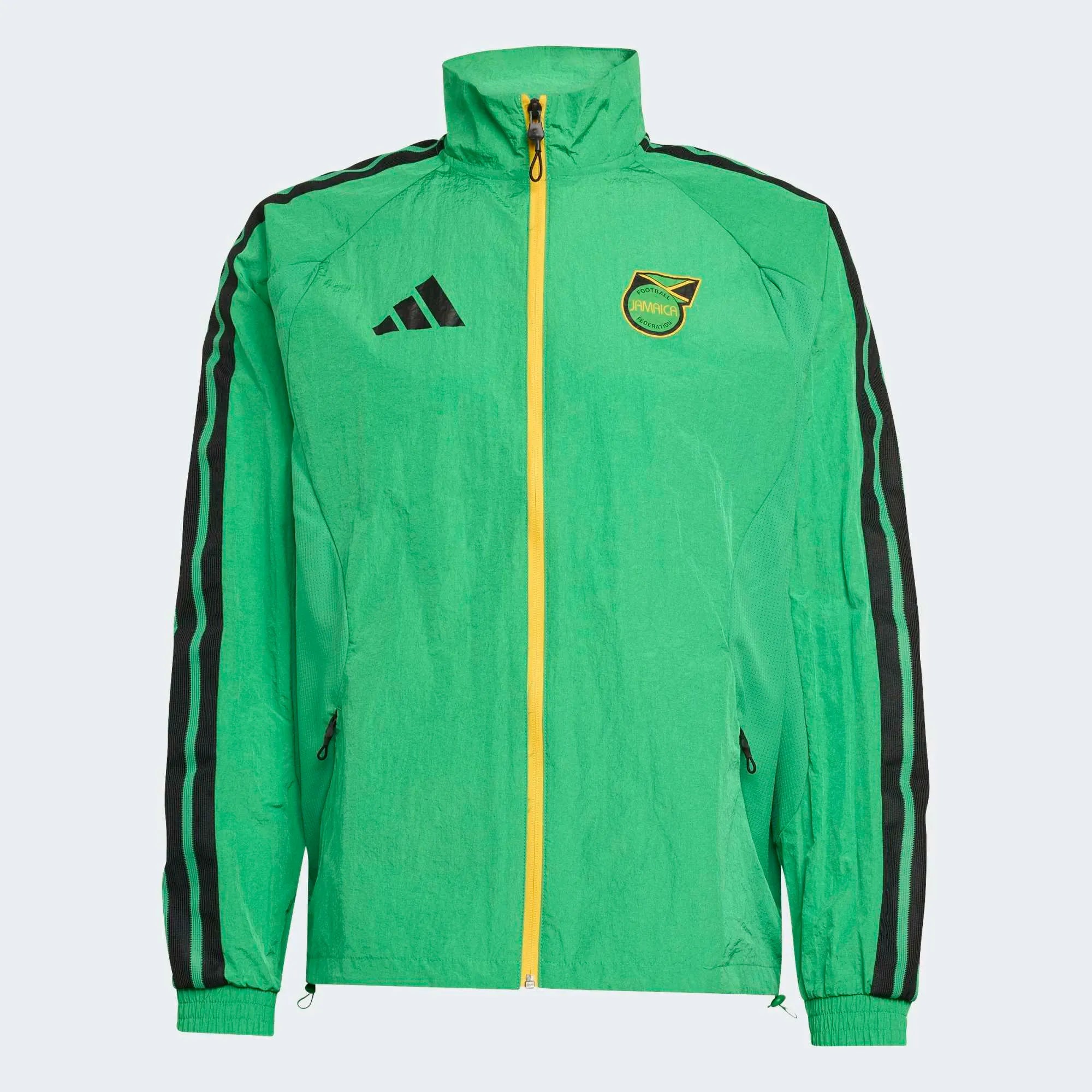 “Adidas Originals Jamaica Home Anthem Jacket in Vivid Green mit gelb-schwarzen Details und dem Logo des jamaikanischen Fußballverbandes bei Stickabush Berlin.“