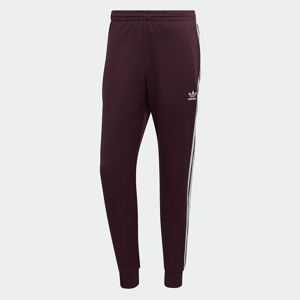 "Adidas Classics SST Track Pants in Weinrot, HK7352, aus Polyester/Baumwolle, schmal geschnitten, klassische adidas Trainingshose mit Streifen."