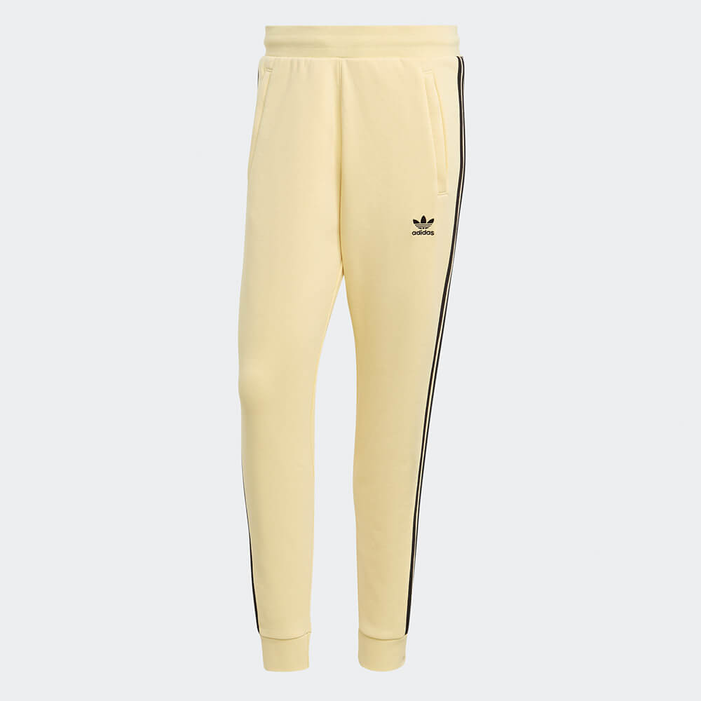 “Adidas Classics 3-Stripes Jogger – Yellow / Black. Gelbe Trainingshose aus weichem Stoff, mit schwarzen 3-Streifen und gesticktem Logo bei Stickabush Berlin."