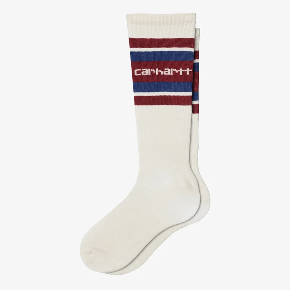 Carhartt WIP Connors Socks – Natural / Scarlet / Wolfsbane. Mehrfarbige Socken aus Baumwollmischung mit Streifenmuster, gerippten Bündchen und gesticktem Carhartt WIP Logo.