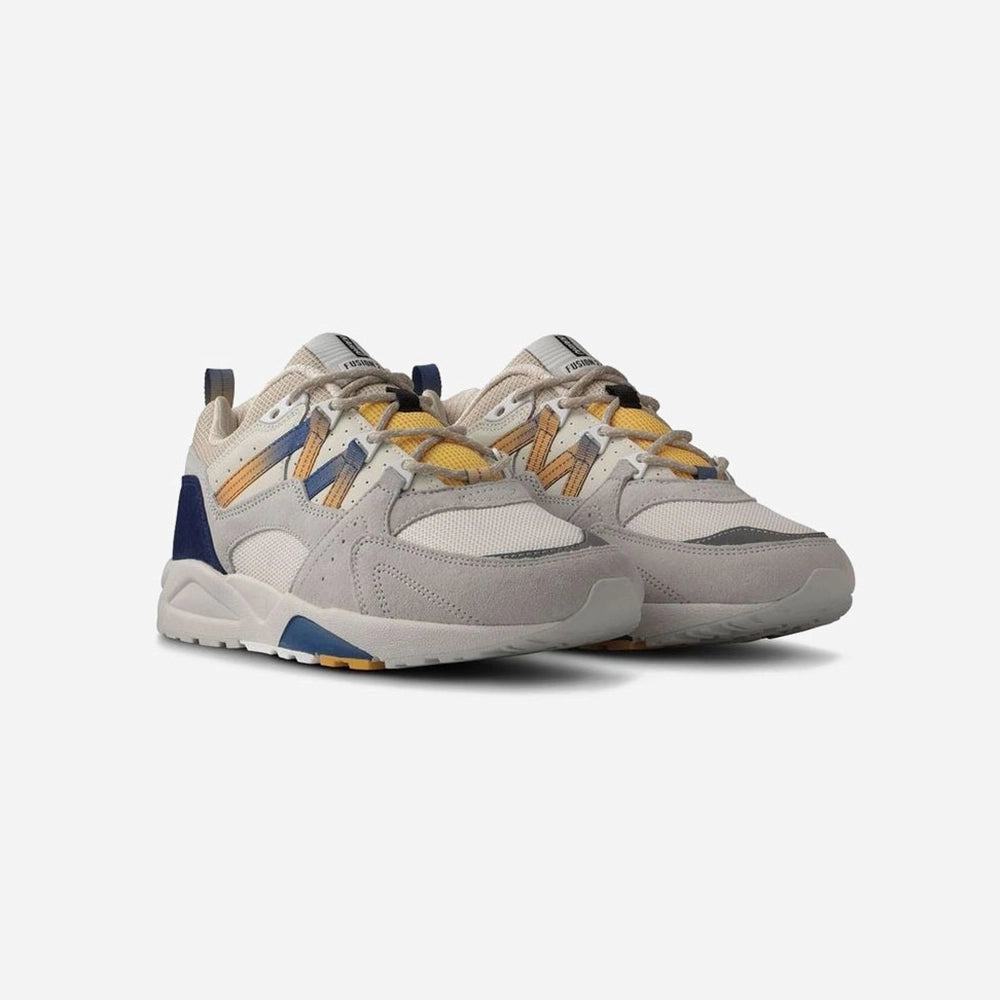 “Karhu Fusion 2.0 – Foggy Dew / True Navy. Graublauer Sneaker aus Wildleder und Mesh, mit reflektierenden Details, EVA-Zwischensohle und Karhu "M-Logo" an der Seite.“