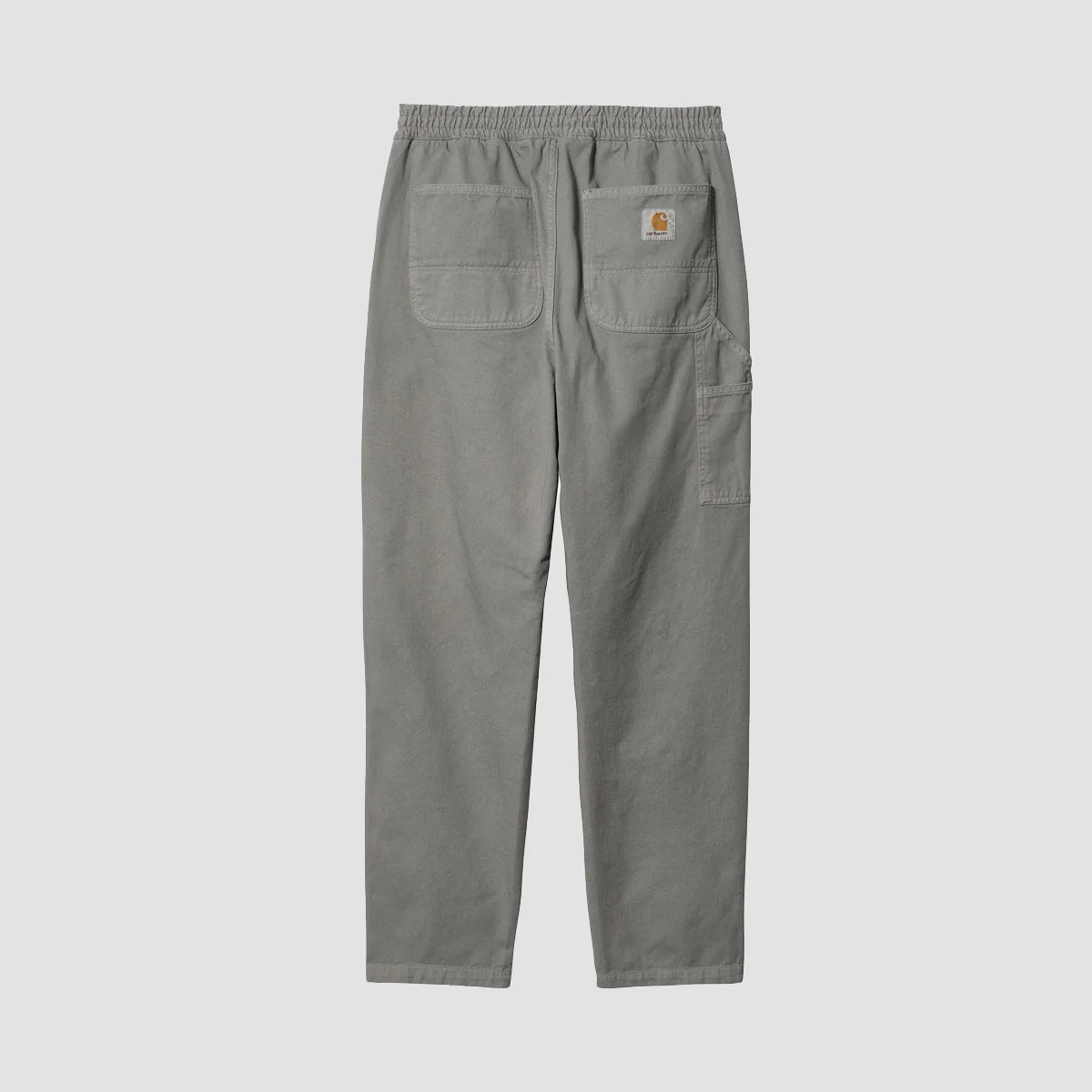 “Helle, nebelgraue ("Misty Grey") Carhartt WIP Flint Pant. Robuste Hose aus stückgefärbtem Baumwoll-Twill. Entspannte, konische Passform, elastischer Bund mit Kordelzug, Werkzeugtaschen und Hammerschlaufe, gewebtes Square Label.“