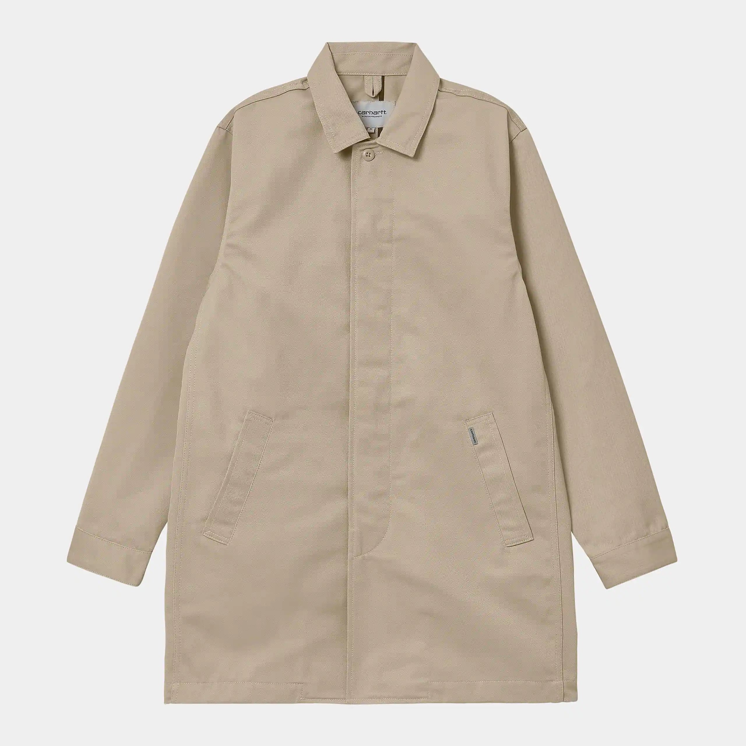 "Carhartt WIP Modular Coat – Wall. Beiger Mantel aus robustem Baumwoll-Twill, mit verdeckte Knopfleiste vorne und aufgesetzten Taschen."