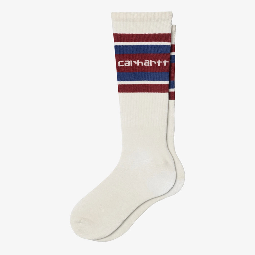 Carhartt WIP Connors Socks – Natural / Scarlet / Wolfsbane. Mehrfarbige Socken aus Baumwollmischung mit Streifenmuster, gerippten Bündchen und gesticktem Carhartt WIP Logo.