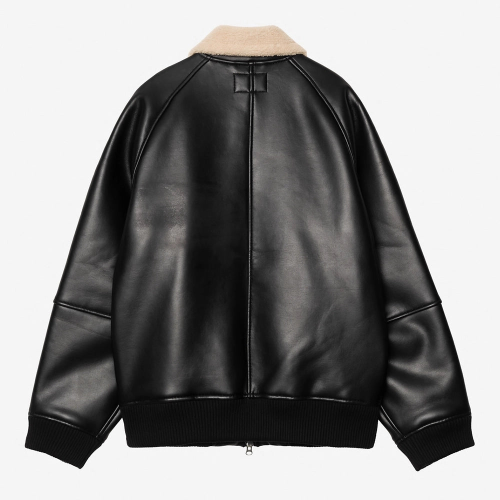 „Carhartt WIP Shepton Jacket in Schwarz/Natur, aus Kunstleder und warmem Fleece, mit Kontrastärmeln, Frontzipper und praktischen Taschen.“