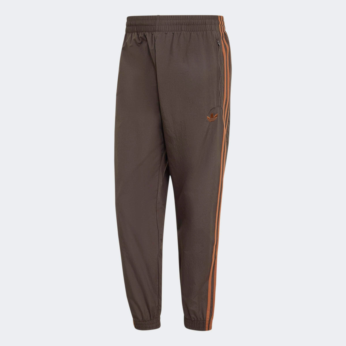 adidas Originals Firebird Woven Track Pants in Aurora Coffee – Vorderansicht der braunen Trainingshose aus Webmaterial mit den ikonischen 3-Stripes.