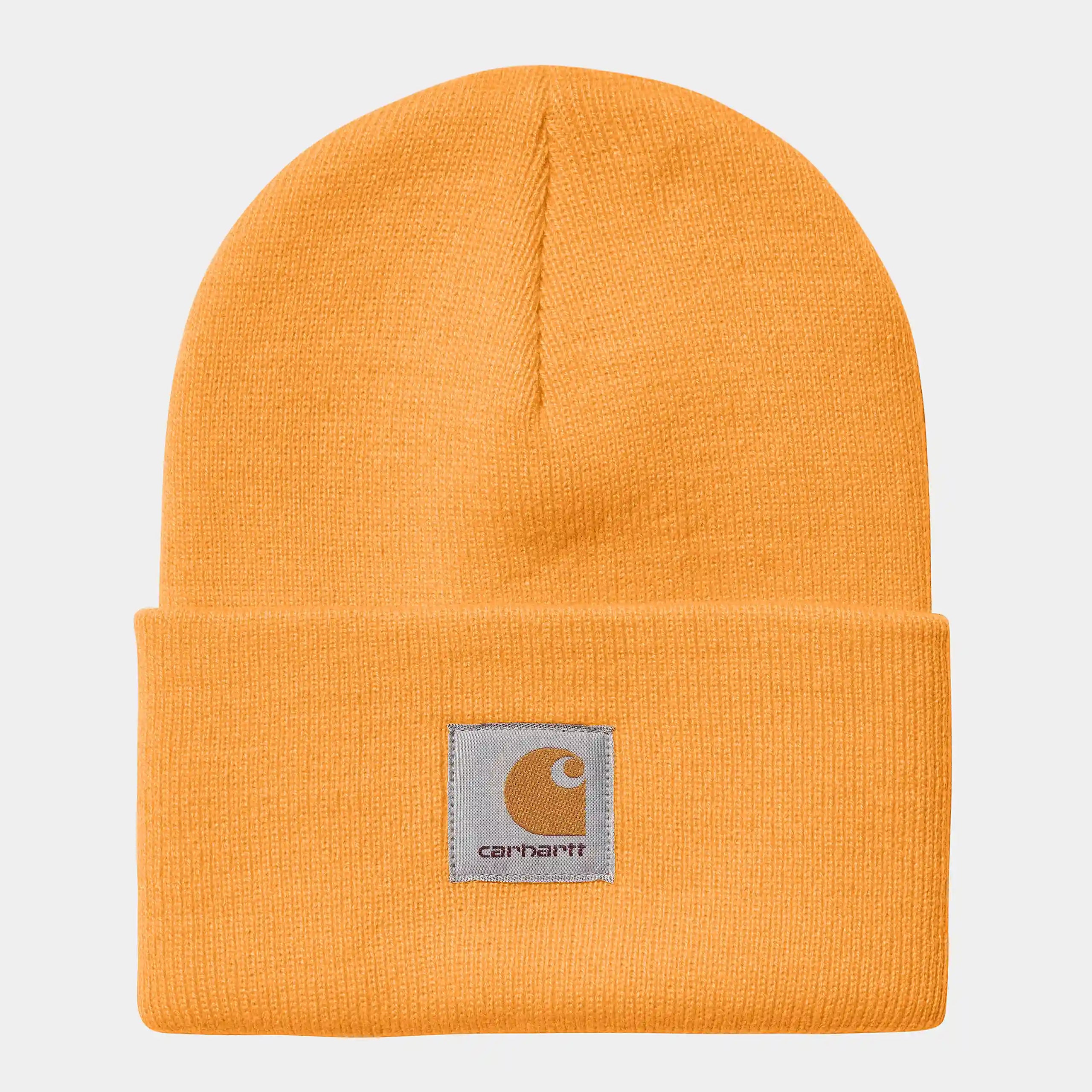 “Helle, orangefarbene Carhartt WIP Acrylic Watch Hat in "Pale Orange". Klassische, gerippte Strickmütze aus Acryl, mit flexiblem Umschlag und kleinem, gewebtem Carhartt Square Label.“