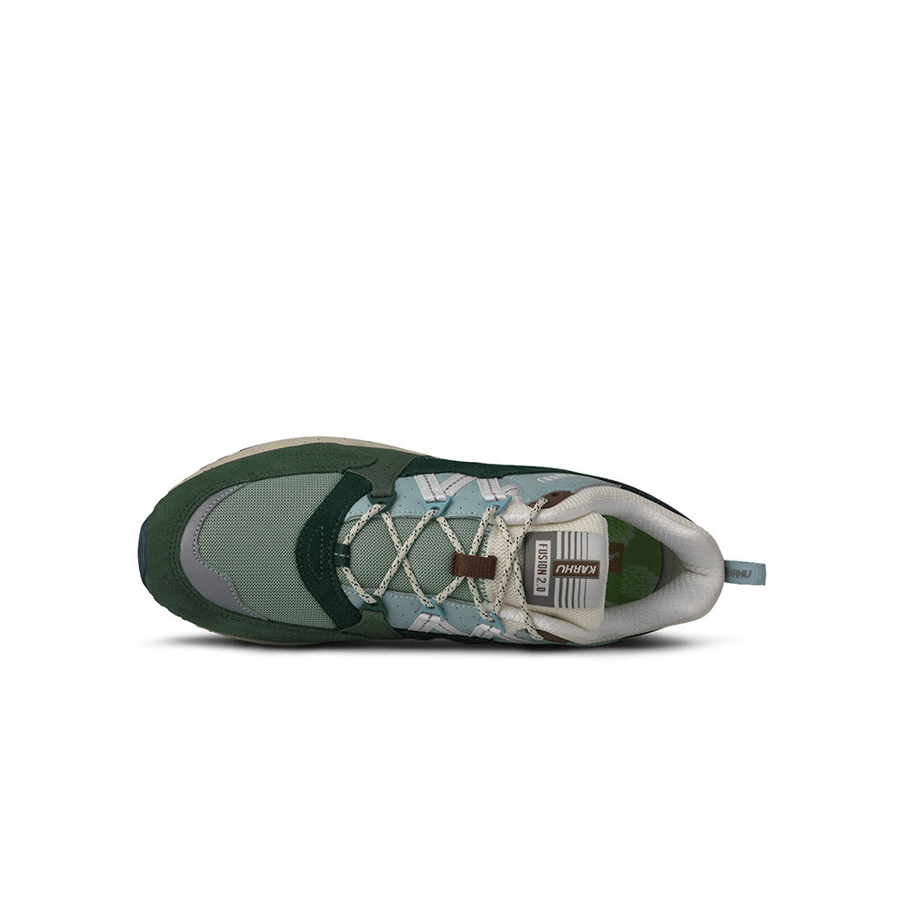 “The Karhu Fusion 2.0 Mölkky Pack in Laurel Wreath / Blanc de Blanc is a retro sneaker with dark and light green panels, white accents, and a beige sole. The elegant Karhu branding appears on the side.“
